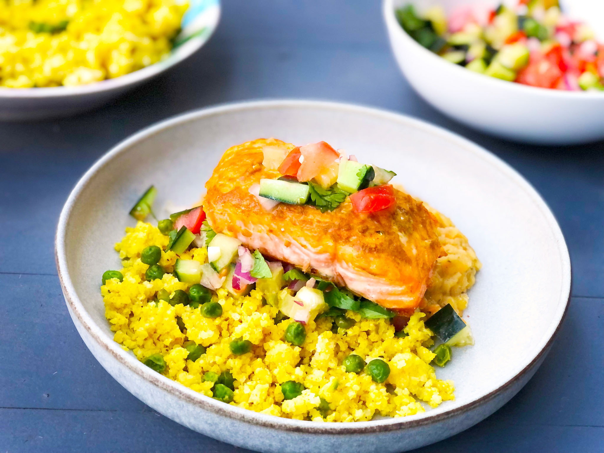 Garlic Spiced Salmon with Kachumber, served with Millet Tahari and Red Lentil Dal Image